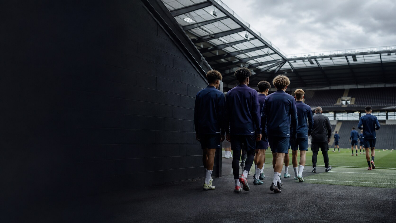 Youth football team walking into a stadium